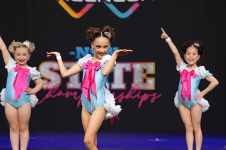 Three young dancers with smiles