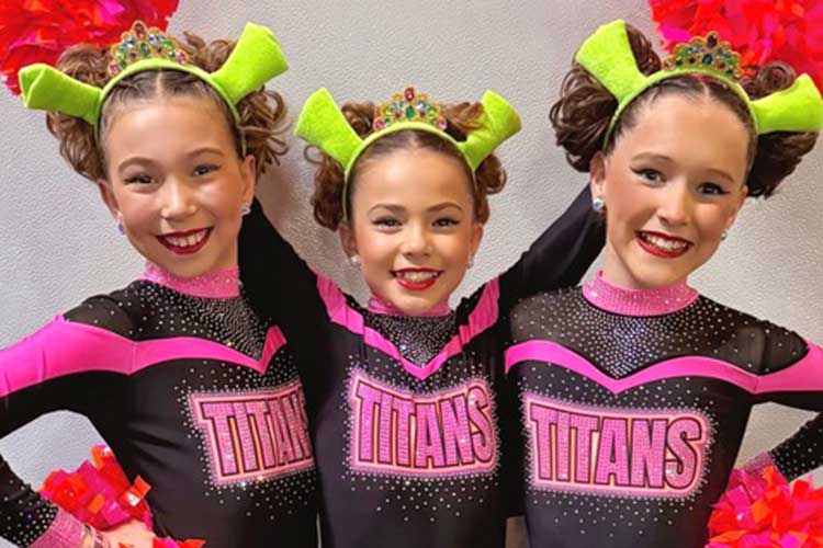 Close up of three Titan Athletics performers